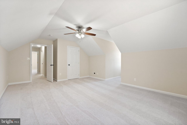 bonus room with baseboards, light colored carpet, lofted ceiling, and a ceiling fan