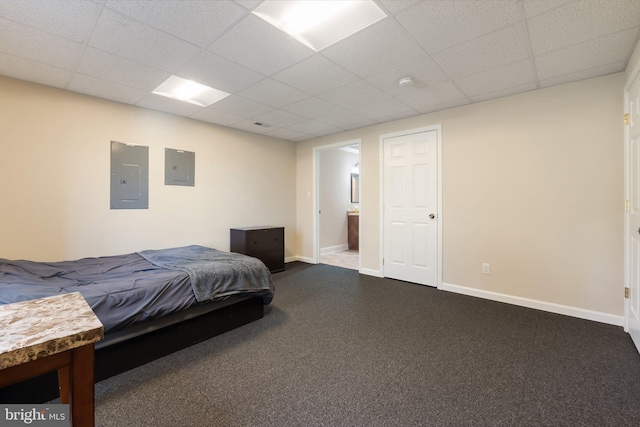 bedroom featuring electric panel, baseboards, dark colored carpet, and a drop ceiling