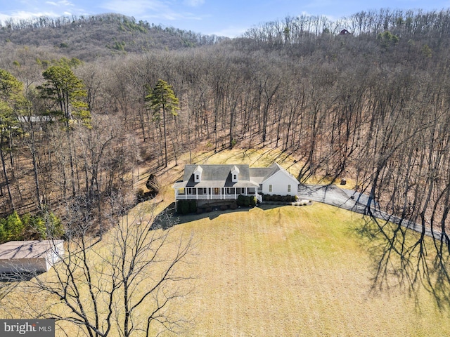 birds eye view of property with a forest view