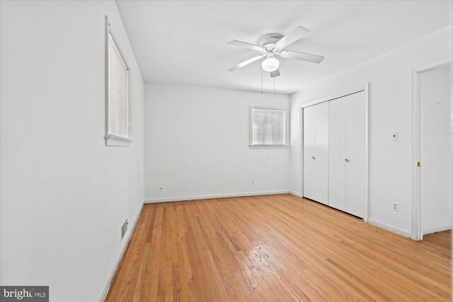 unfurnished bedroom with visible vents, baseboards, ceiling fan, light wood-style flooring, and a closet