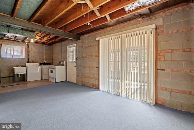 below grade area with washing machine and clothes dryer and a sink