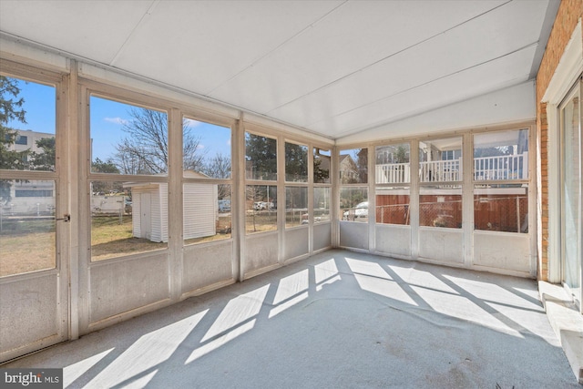 unfurnished sunroom with lofted ceiling