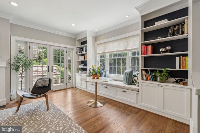 living area with crown molding, french doors, light wood-type flooring, plenty of natural light, and recessed lighting