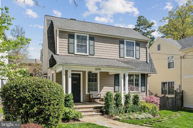 view of front of home featuring covered porch and roof with shingles