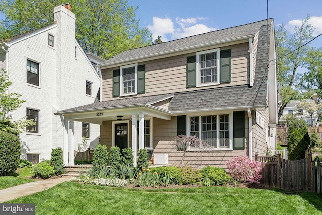 view of front of property featuring covered porch and roof with shingles