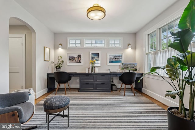 sitting room with wood finished floors, an office area, and baseboards