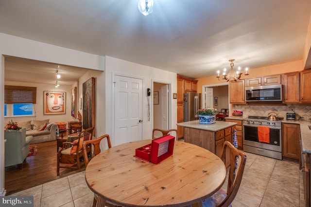 dining space with an inviting chandelier and light tile patterned flooring