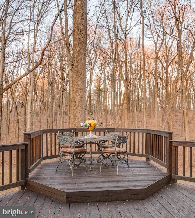 wooden terrace featuring outdoor dining space