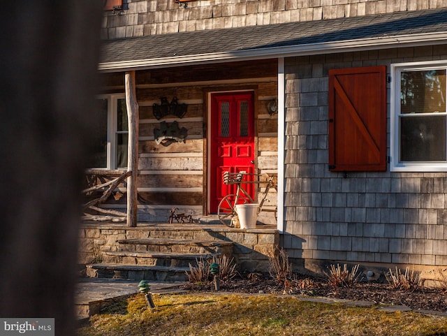 property entrance with a shingled roof