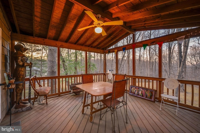 sunroom / solarium featuring a ceiling fan, wooden ceiling, and vaulted ceiling with beams