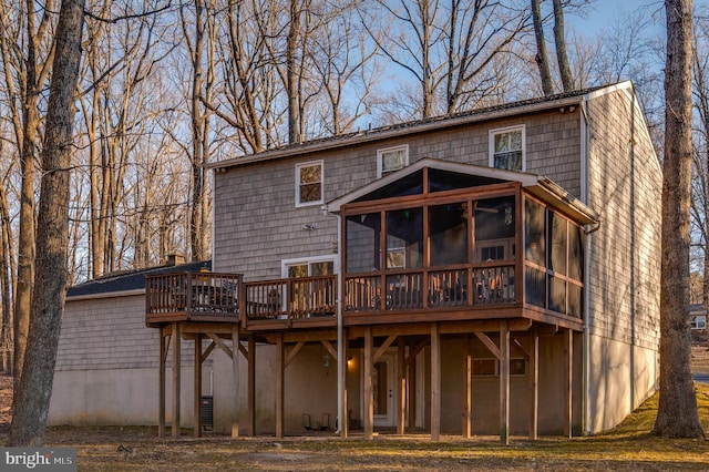 rear view of house with a deck and a sunroom