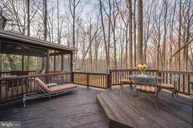 wooden terrace with outdoor dining space