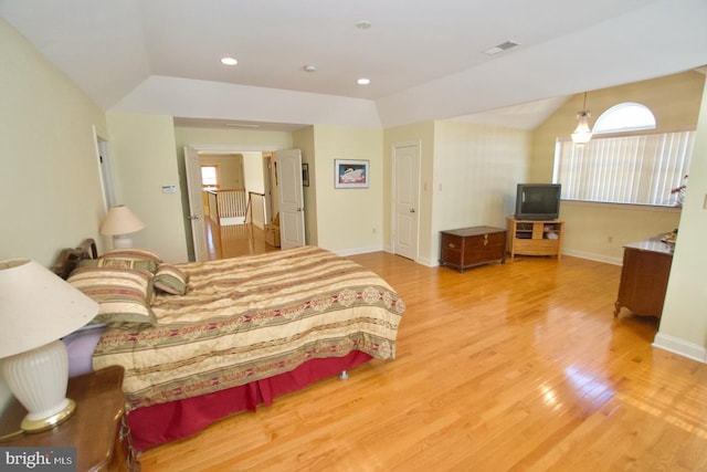 bedroom featuring vaulted ceiling, wood finished floors, and baseboards