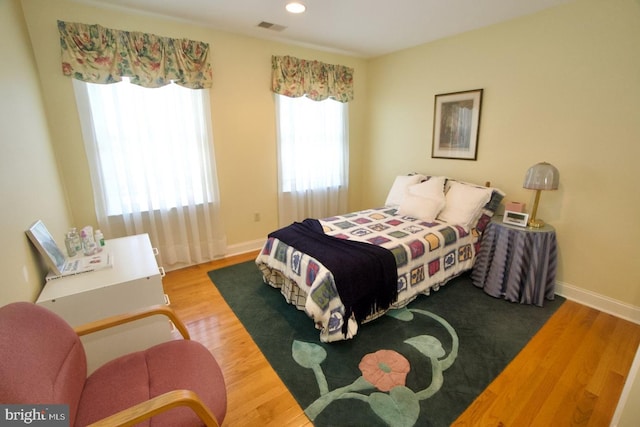 bedroom featuring visible vents, recessed lighting, baseboards, and wood finished floors