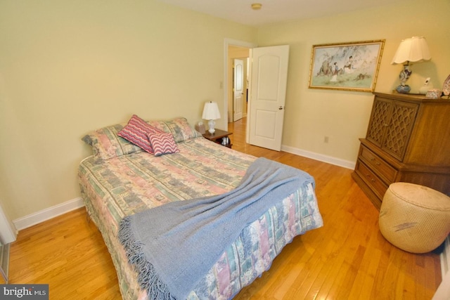 bedroom with baseboards and wood finished floors