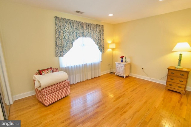 living area with recessed lighting, light wood-style floors, visible vents, and baseboards