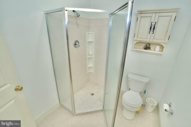 full bathroom featuring tile patterned flooring, a shower stall, and toilet