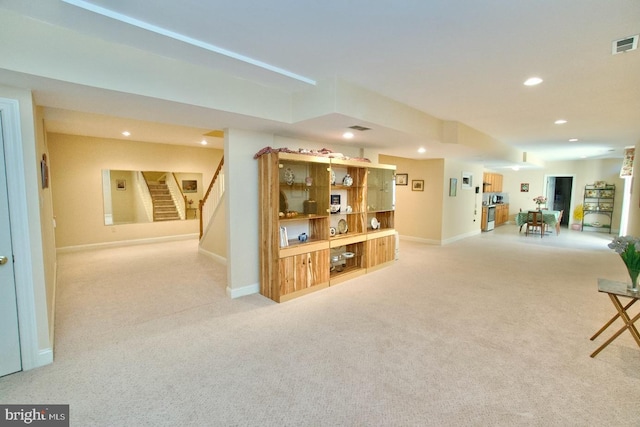 sitting room featuring visible vents, baseboards, stairway, light carpet, and recessed lighting