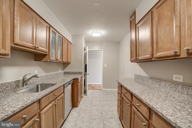 kitchen with a sink, glass insert cabinets, brown cabinets, and stainless steel dishwasher