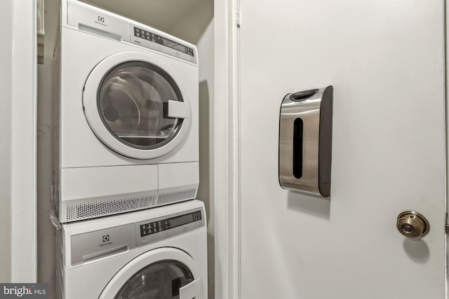 clothes washing area featuring laundry area and stacked washer / dryer