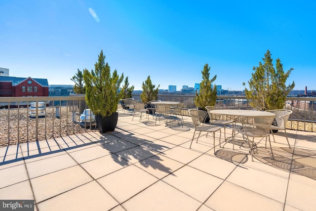 view of patio with a view of city and outdoor dining area