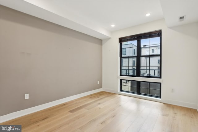 spare room with recessed lighting, visible vents, baseboards, and light wood-style floors