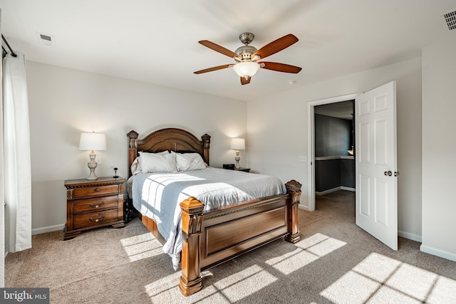 bedroom with visible vents, baseboards, and light colored carpet