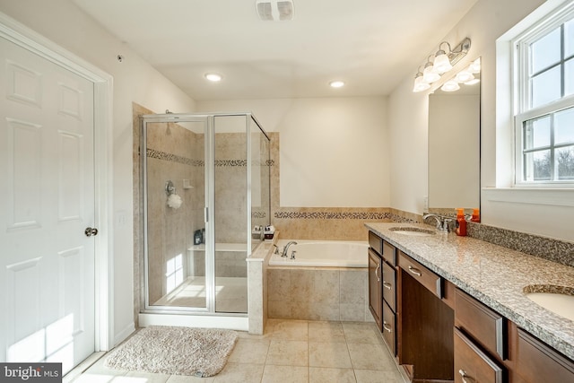 full bathroom featuring visible vents, a shower stall, a garden tub, tile patterned floors, and a sink