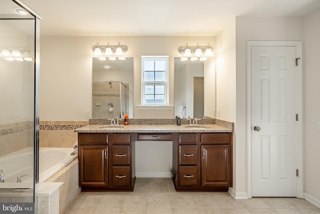 full bath with a sink, double vanity, a bath, and a shower stall