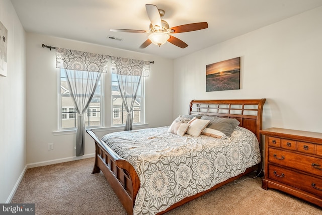 bedroom with visible vents, light carpet, baseboards, and a ceiling fan