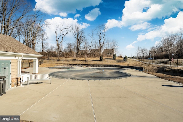 view of swimming pool featuring a patio, a jacuzzi, and fence