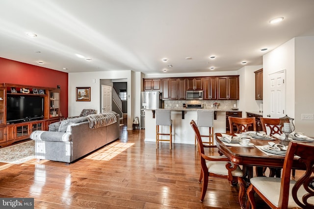 dining space featuring recessed lighting and light wood-style flooring