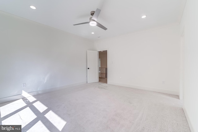 carpeted empty room featuring recessed lighting, baseboards, a ceiling fan, and crown molding