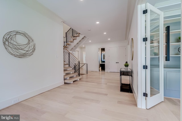 foyer entrance featuring recessed lighting, light wood-type flooring, baseboards, and stairs