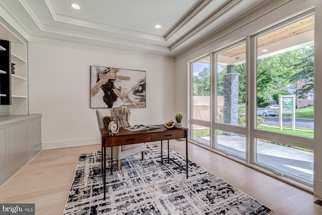 office featuring recessed lighting, a tray ceiling, baseboards, and wood finished floors