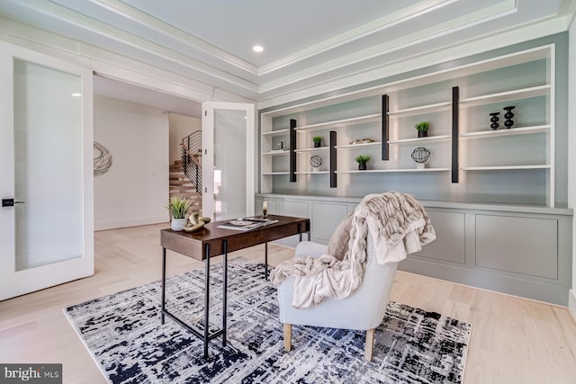 office space featuring built in shelves, recessed lighting, light wood-type flooring, and ornamental molding