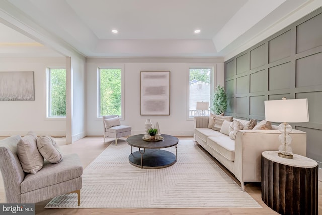 living area with a decorative wall and recessed lighting