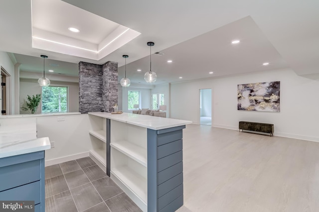 kitchen featuring open shelves, baseboards, open floor plan, and hanging light fixtures