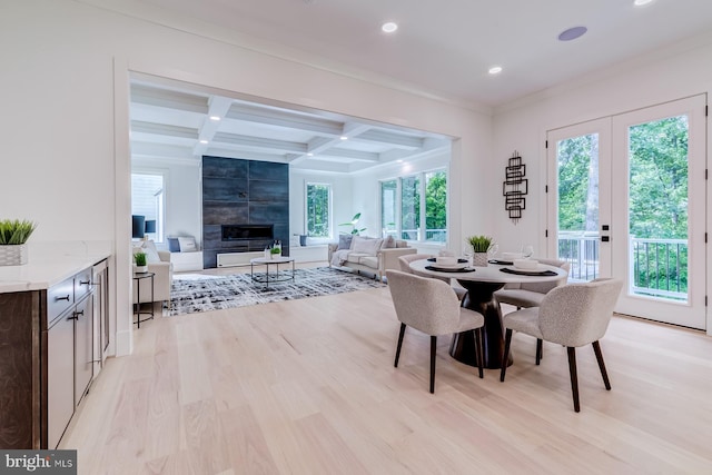 dining area with coffered ceiling, beam ceiling, light wood-style flooring, recessed lighting, and a fireplace