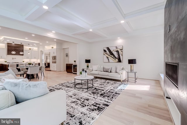 living room featuring light wood-style floors, beam ceiling, and coffered ceiling