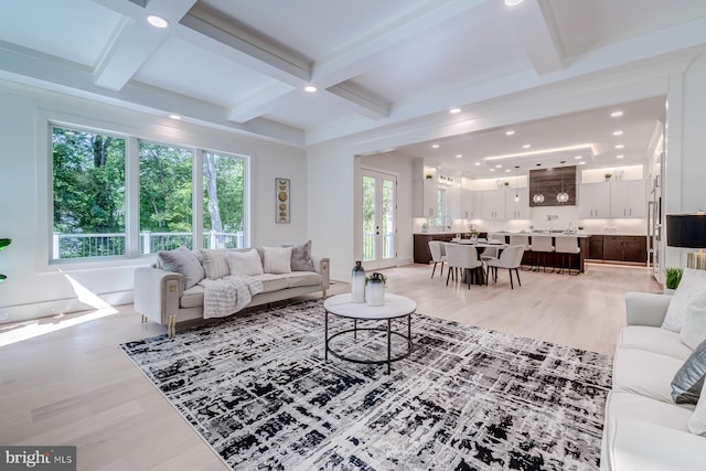 living room featuring beam ceiling, recessed lighting, light wood-style floors, and coffered ceiling