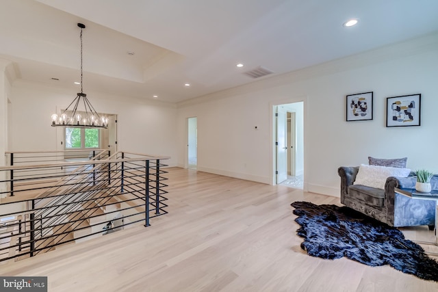 interior space with crown molding, wood finished floors, visible vents, and a chandelier