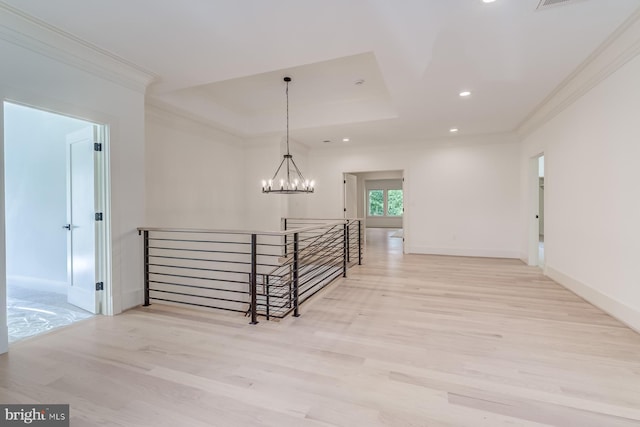 corridor with baseboards, ornamental molding, an upstairs landing, wood finished floors, and a notable chandelier