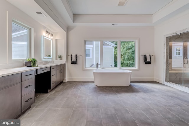 full bath featuring vanity, visible vents, baseboards, a soaking tub, and a stall shower