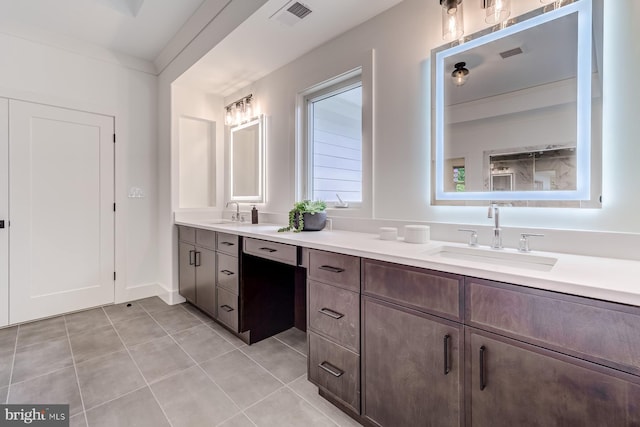 full bath with double vanity, visible vents, tile patterned flooring, and a sink