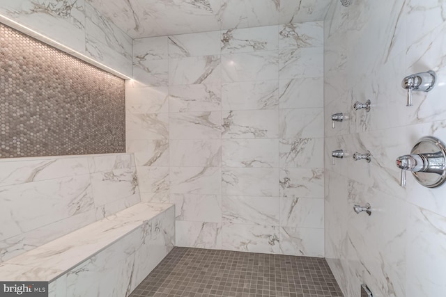 full bath featuring a tile shower