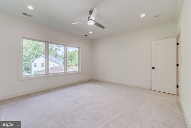 spare room featuring visible vents, baseboards, ornamental molding, light carpet, and recessed lighting