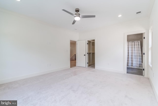 unfurnished bedroom featuring baseboards, carpet, visible vents, and ornamental molding