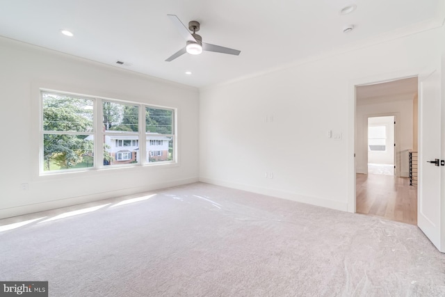 carpeted empty room featuring a wealth of natural light, visible vents, recessed lighting, and baseboards