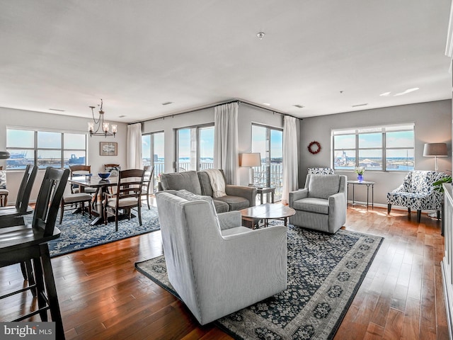 living room featuring an inviting chandelier and wood-type flooring